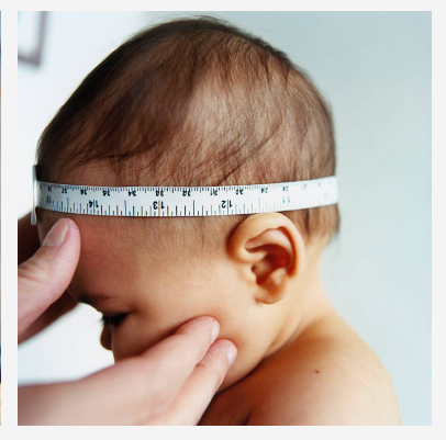 A close-up of a baby's head with a measuring tape wrapped around the forehead to determine head circumference, held by an adult's hands against a light background.
