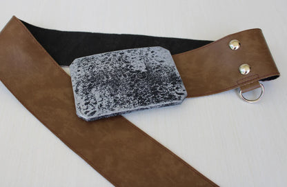 Close-up of Luke Skywalker costume belt buckle — wide brown leather belt with distressed silver rectangular buckle, two silver snaps and a D-ring attached