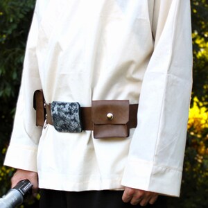 Adult Luke Skywalker costume belt — brown leather utility belt with snap pouches and distress paint buckle in silver, worn over cream tunic