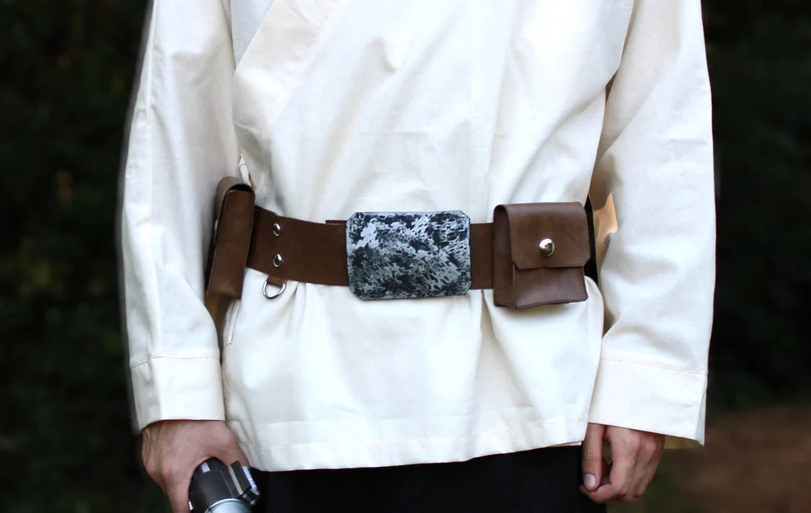 Adult Luke Skywalker costume belt — brown leather utility belt with snap pouches and  distress silver buckle, 2 silver snaps and a D-ring attached   worn over cream tunic